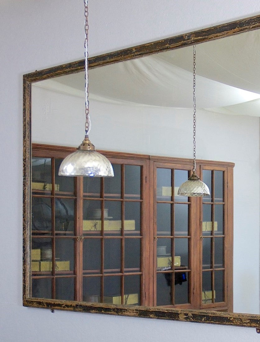 A mid c19th ebonised shop mirror