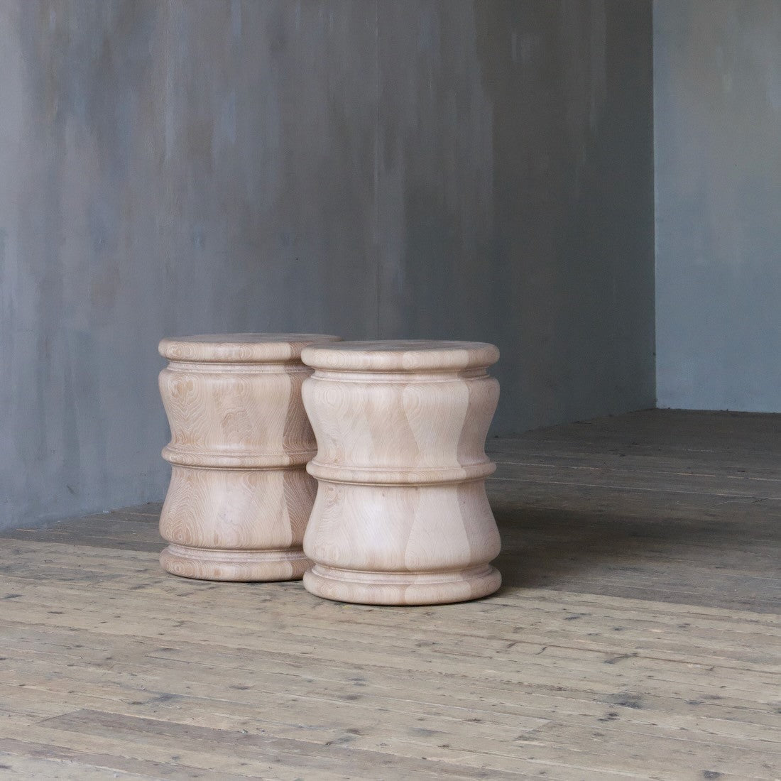 A pair of bespoke turned side tables