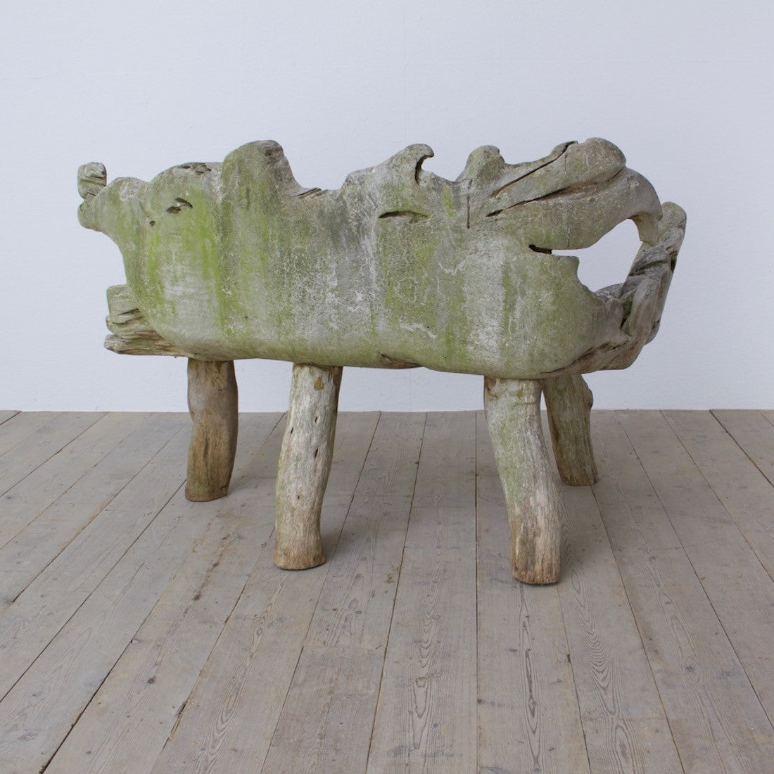 A sculptural 'splash' teak bench