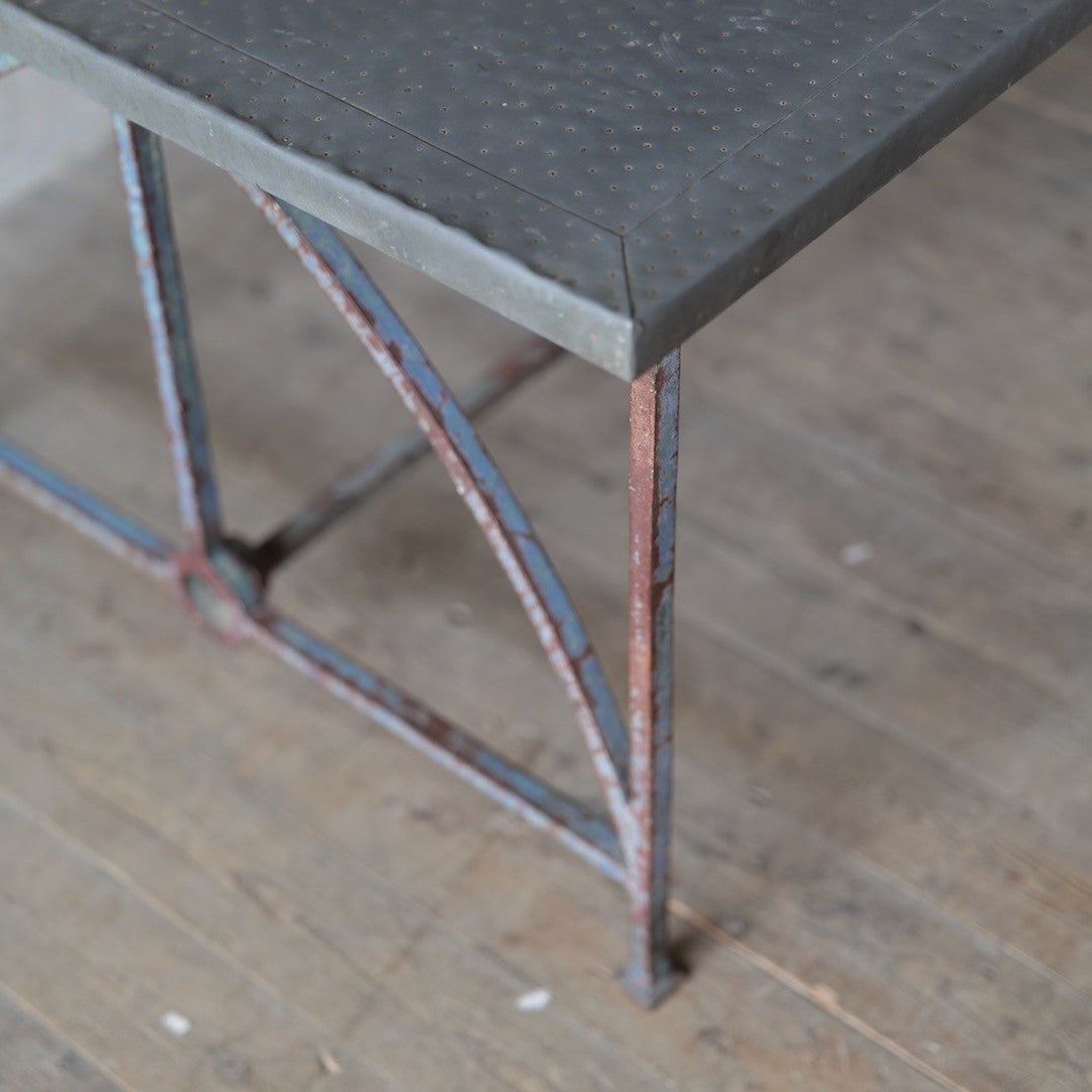 An architectural iron and zinc dining table