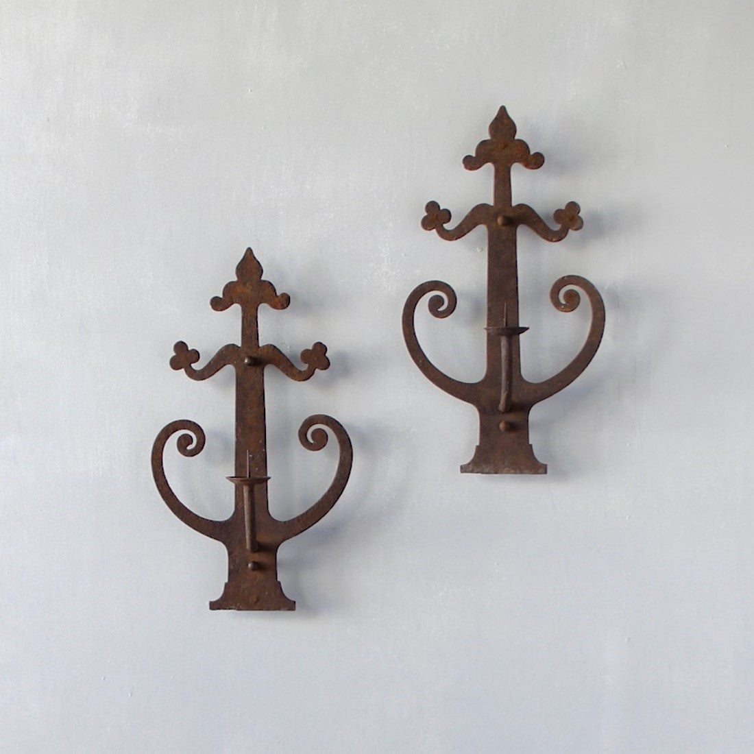 A pair of wrought iron sconces