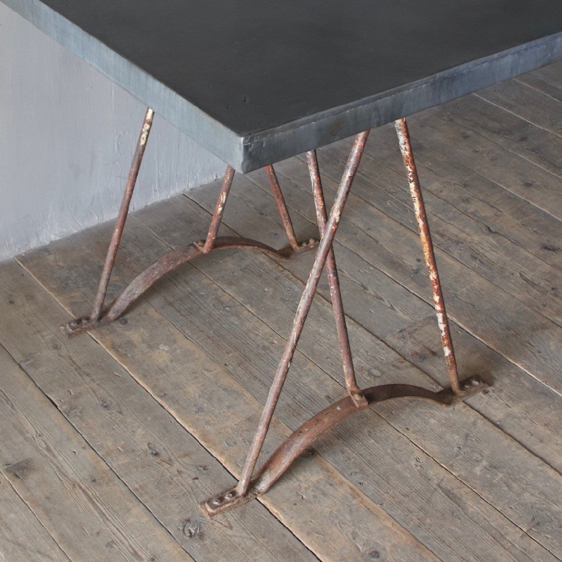 An architectural wrought iron trestle table