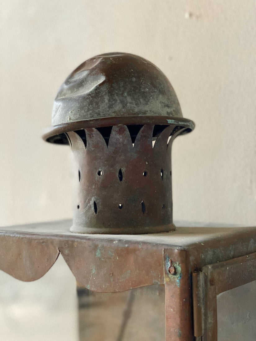 A primitive copper wall lantern