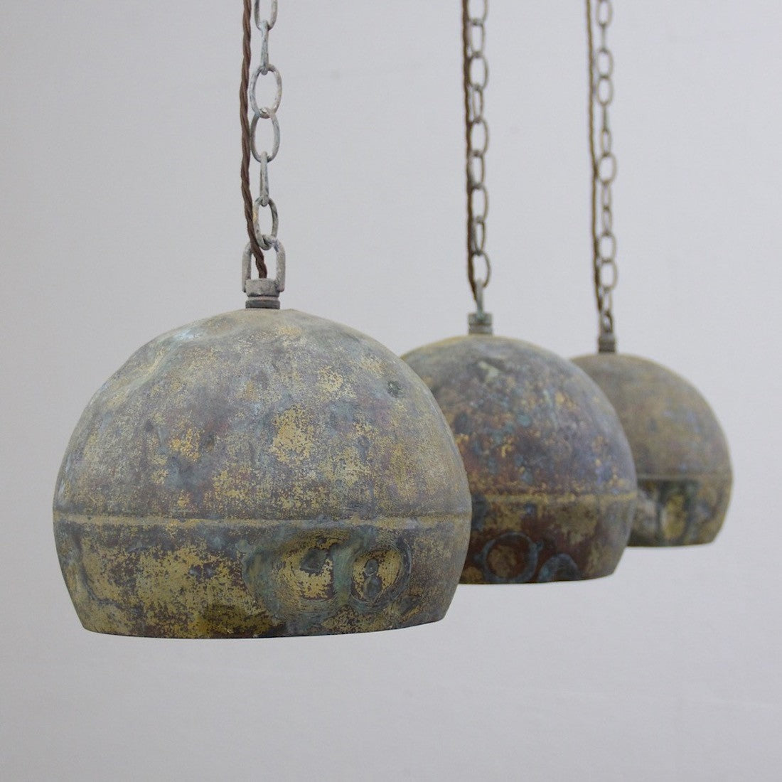A set of three copper pendant lights