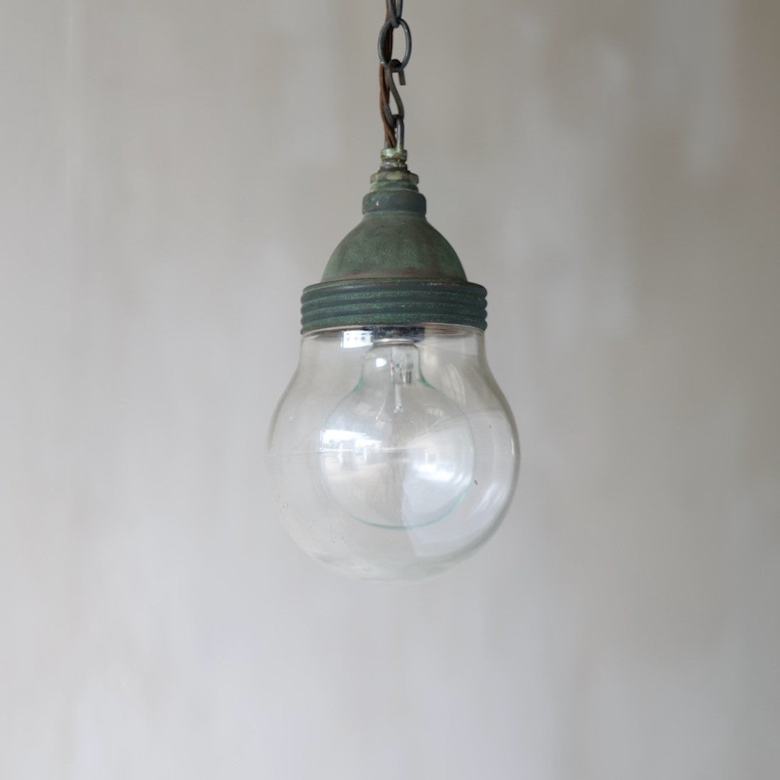 A small copper globe pendant light