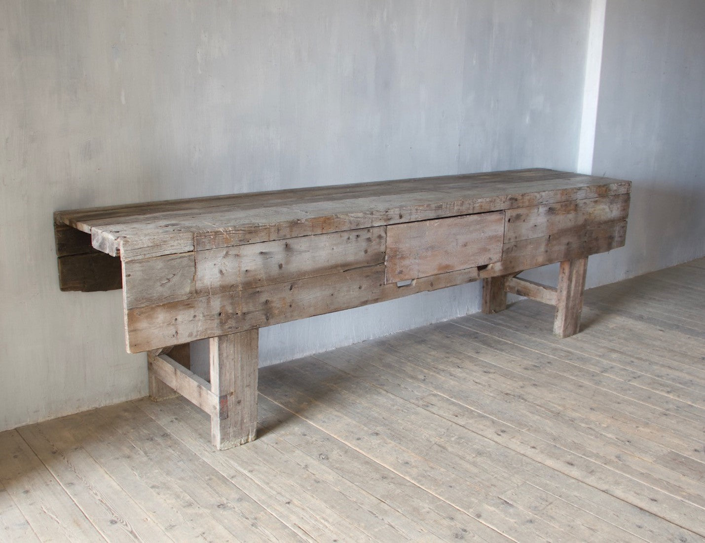 A large weathered work table