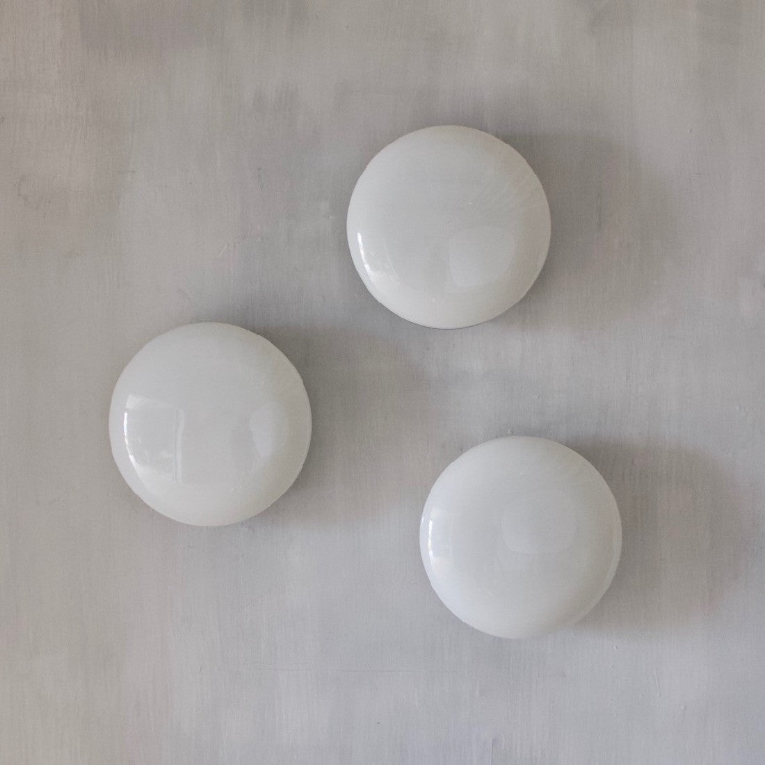 A set of three opaline lights