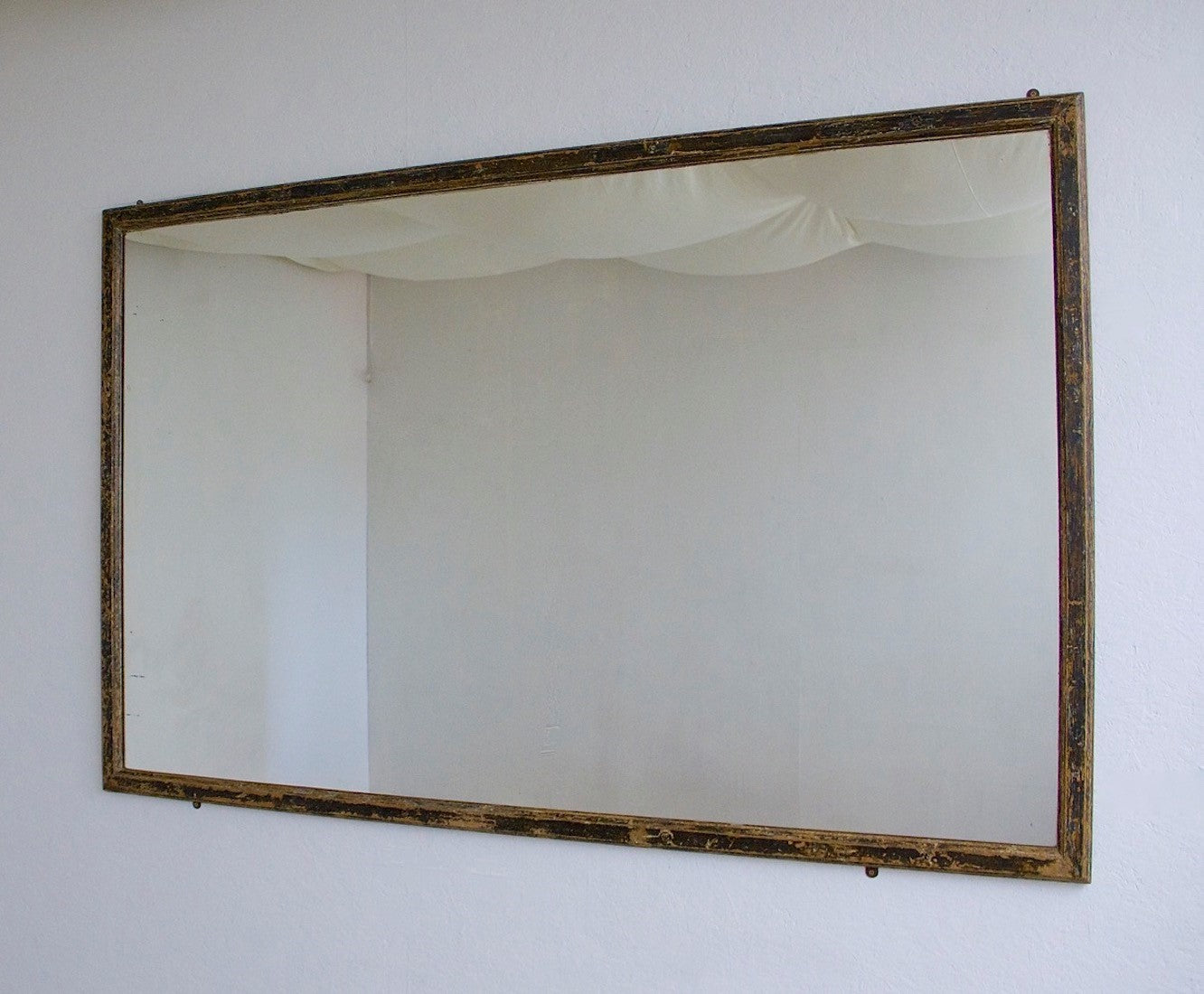 A mid c19th ebonised shop mirror