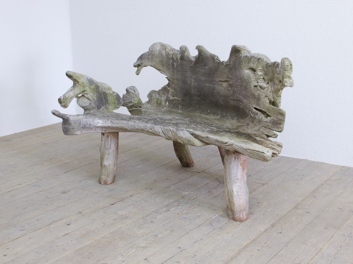A sculptural 'splash' teak bench