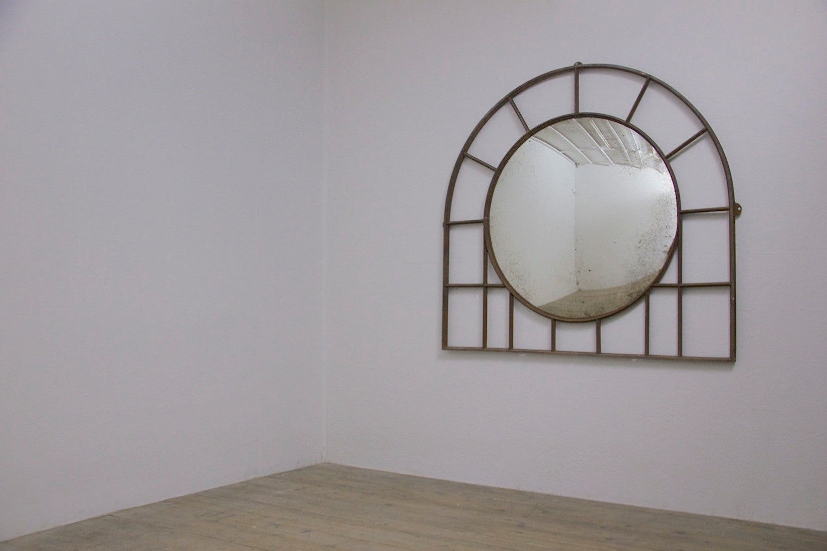 A large C19th wrought iron convex mirror