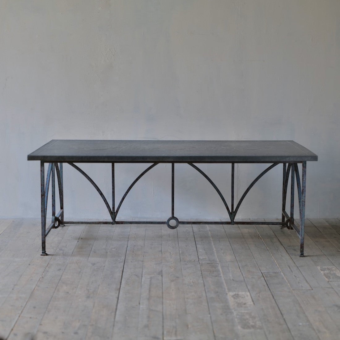 An architectural iron and zinc dining table