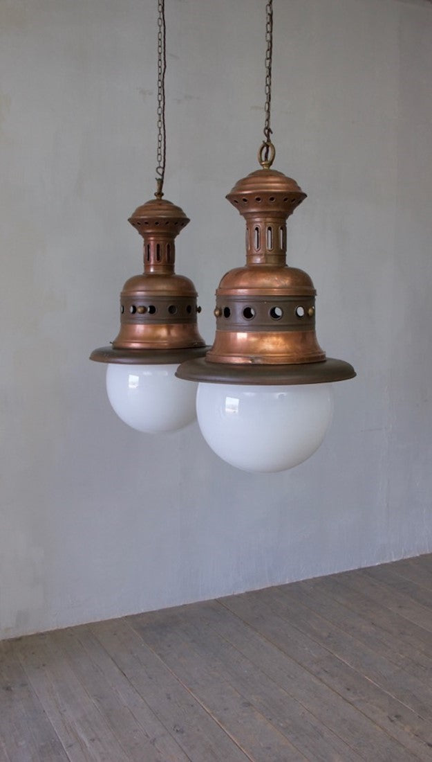 A pair of large copper pendants