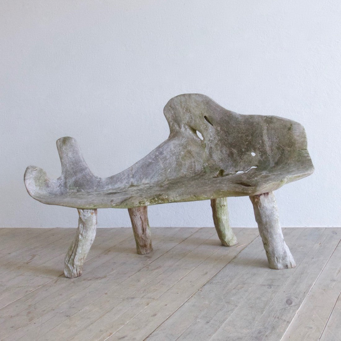 A sculptural teak bench