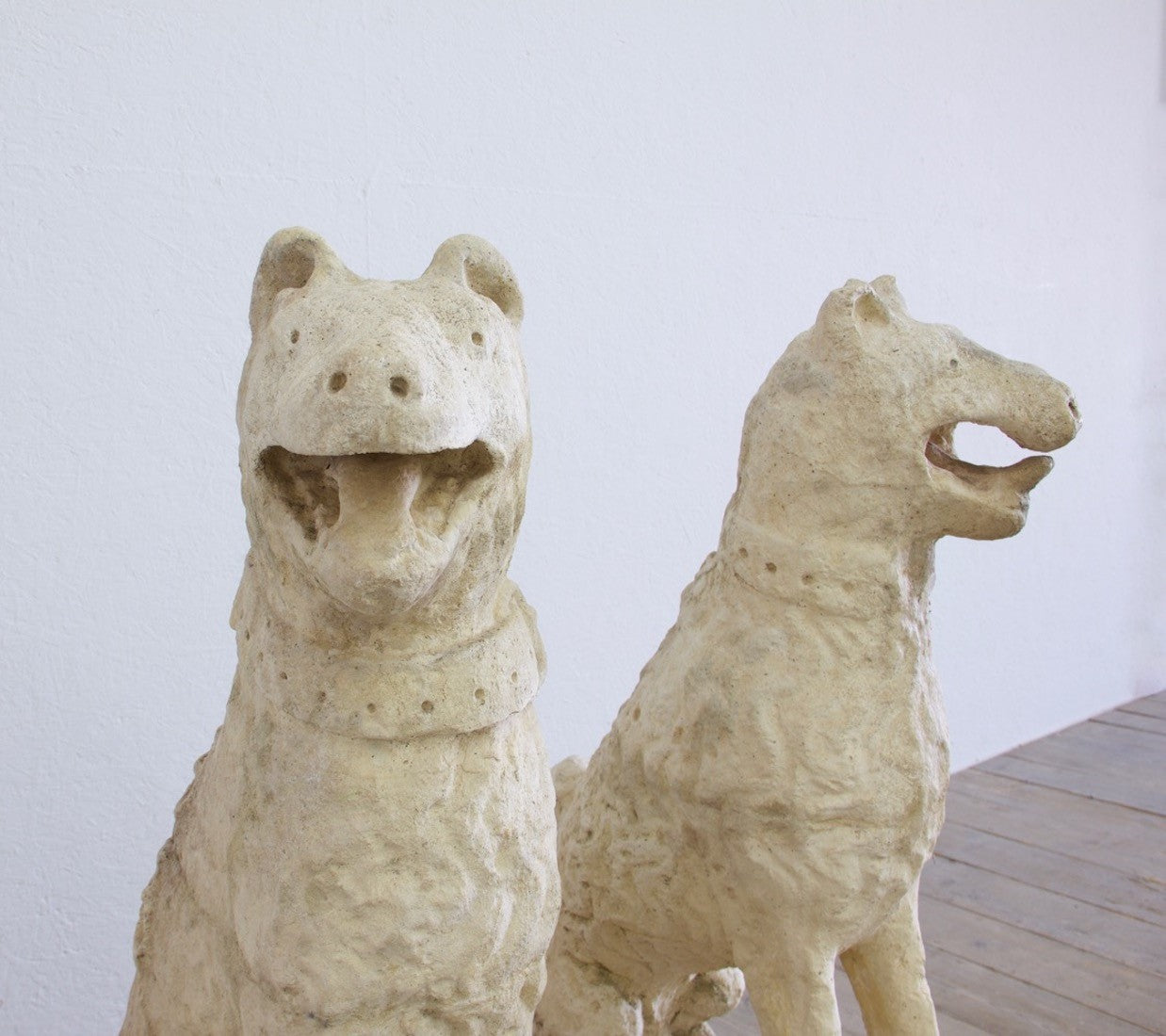 A pair of cast stone dogs