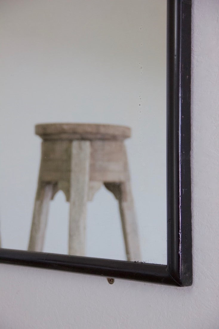 A large ebonised shop mirror