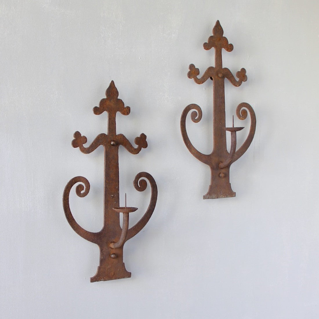 A pair of wrought iron sconces