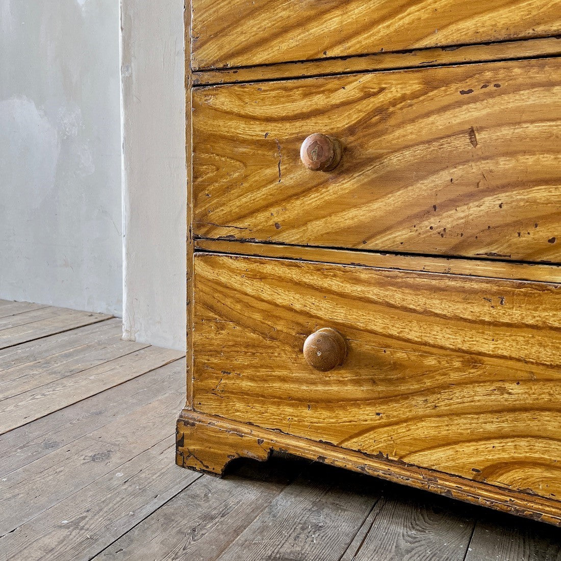 A faux elm painted chest of drawers