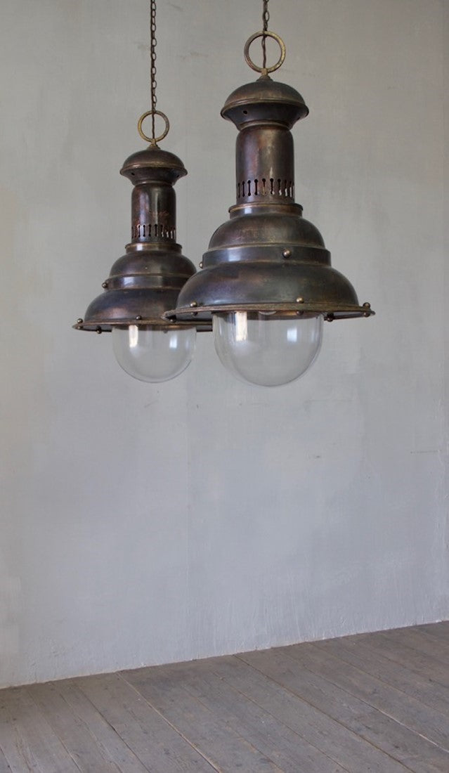 A pair of large brass pendants