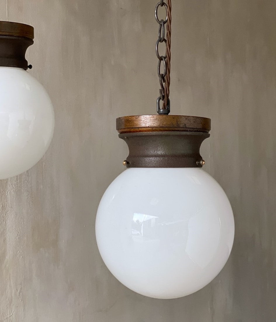 A pair of globe pendant lights