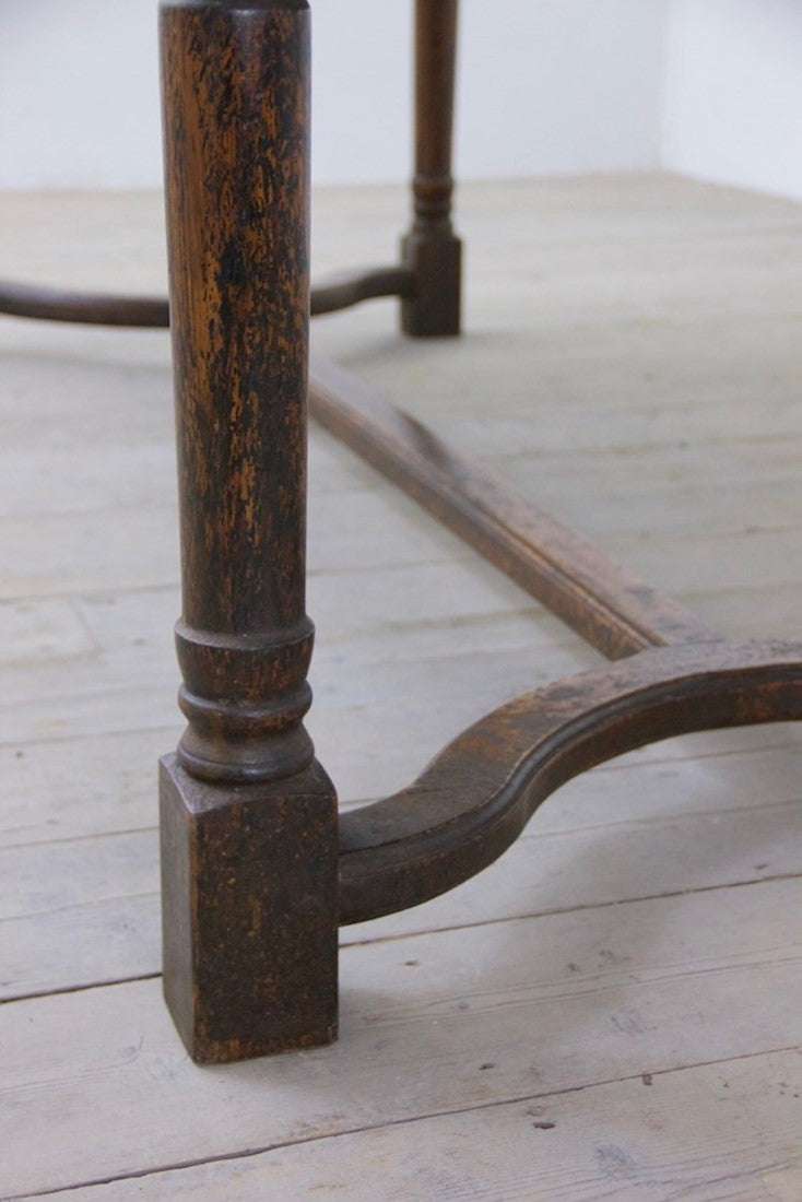 A heavily patinated oak table