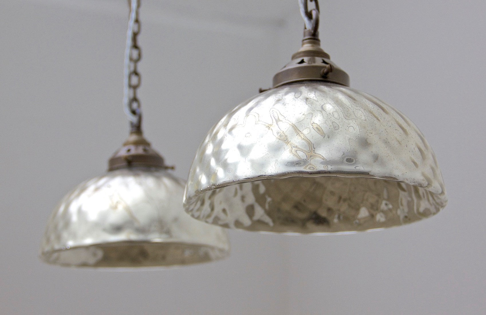 A pair of mercury glass pendant lights
