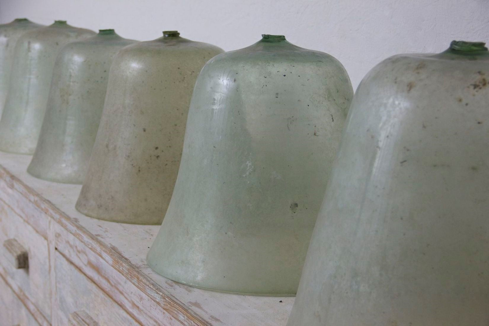 8 large early C20th melon cloches