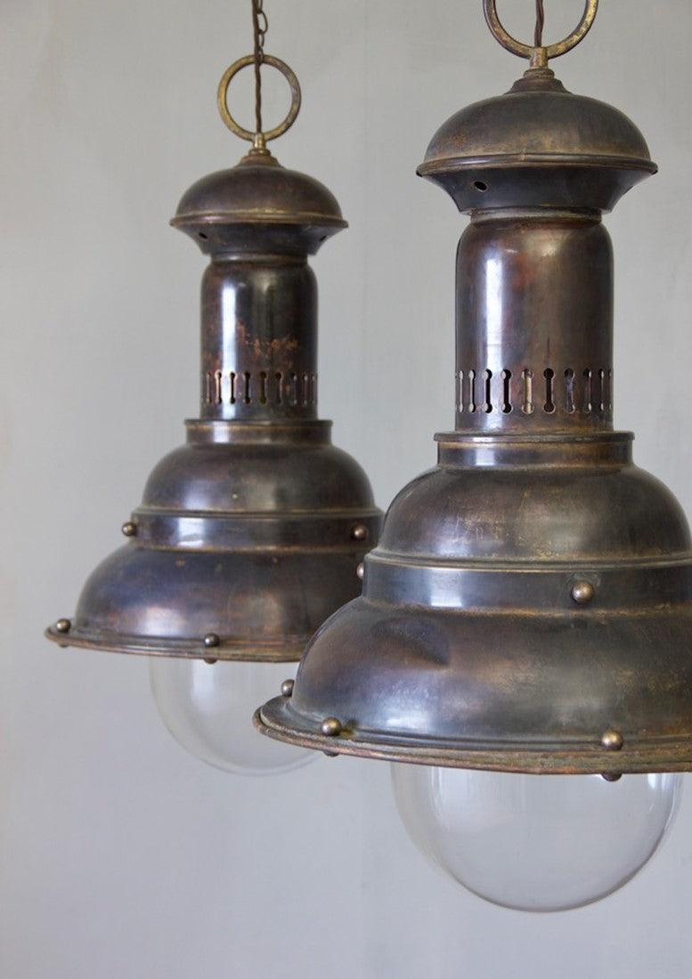 A pair of large brass pendants