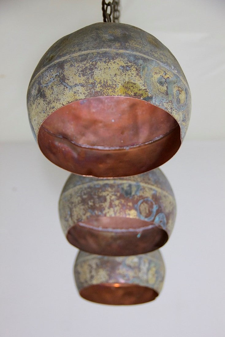 A set of three copper pendant lights