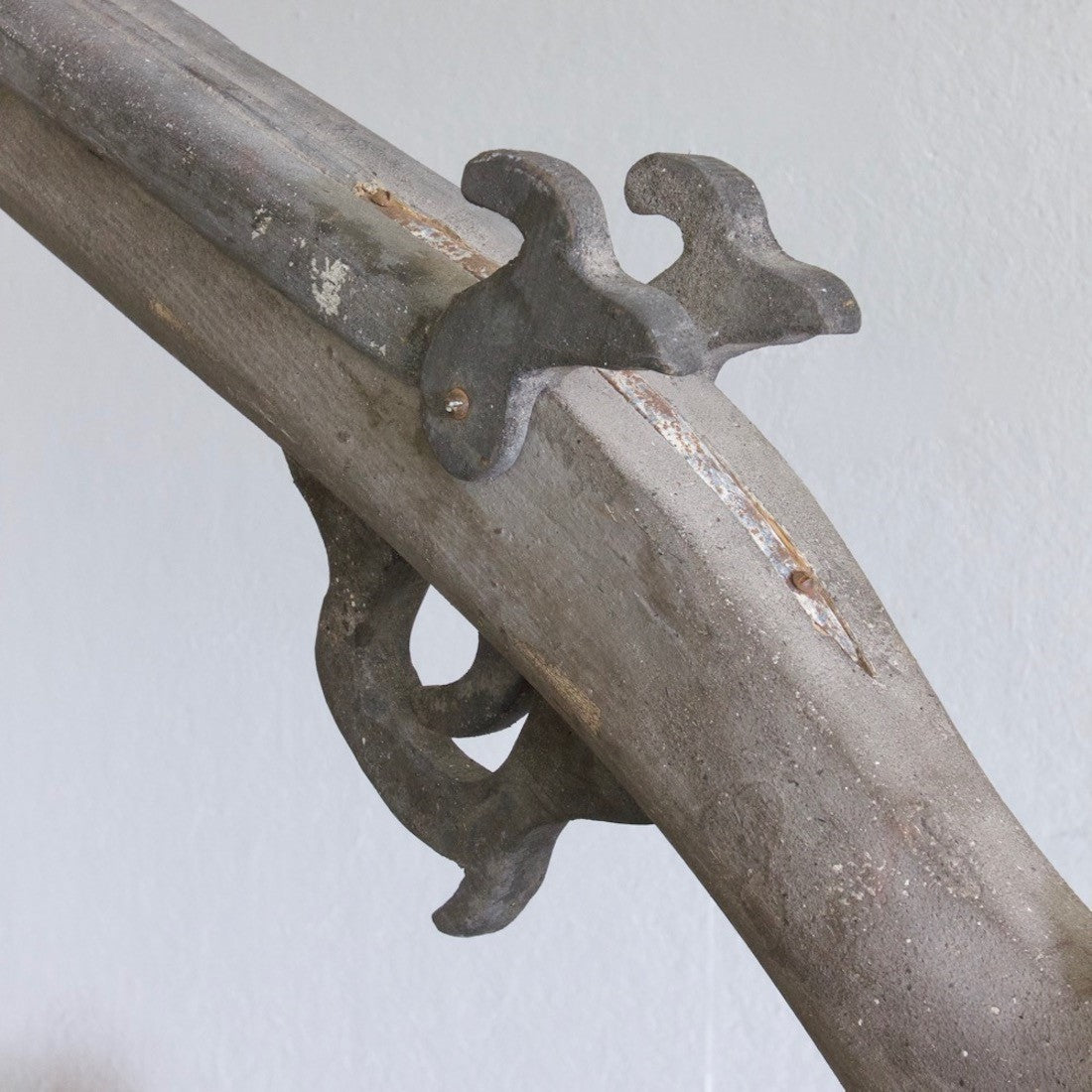 An oversized wooden model of a gun