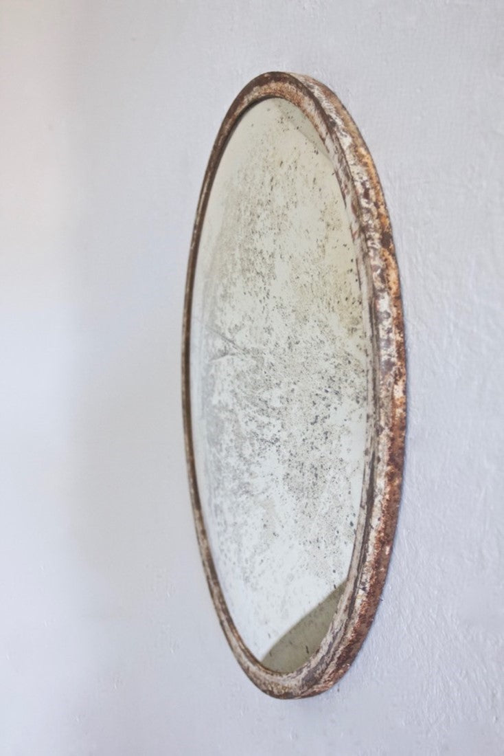 An iron-framed convex mirror